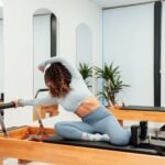 a woman is doing exercises on a pilates